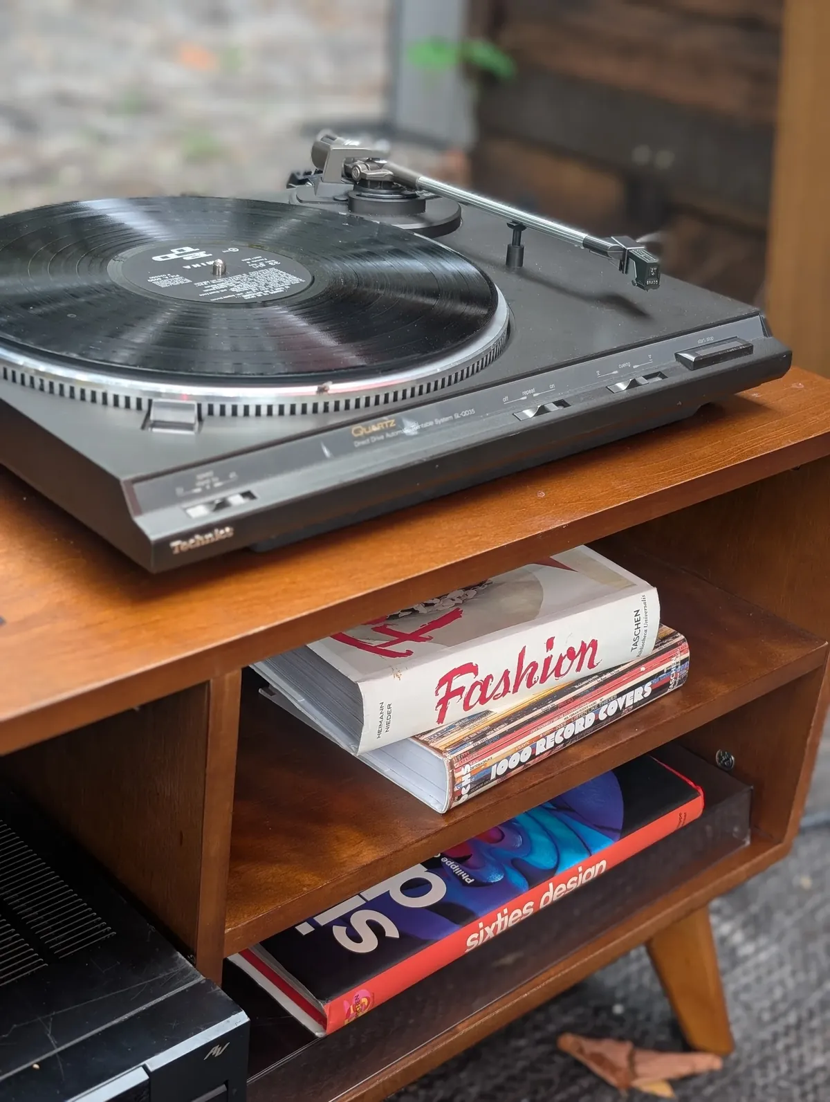 Technics SL-QD35 turntable on a mid-century credenza with design books